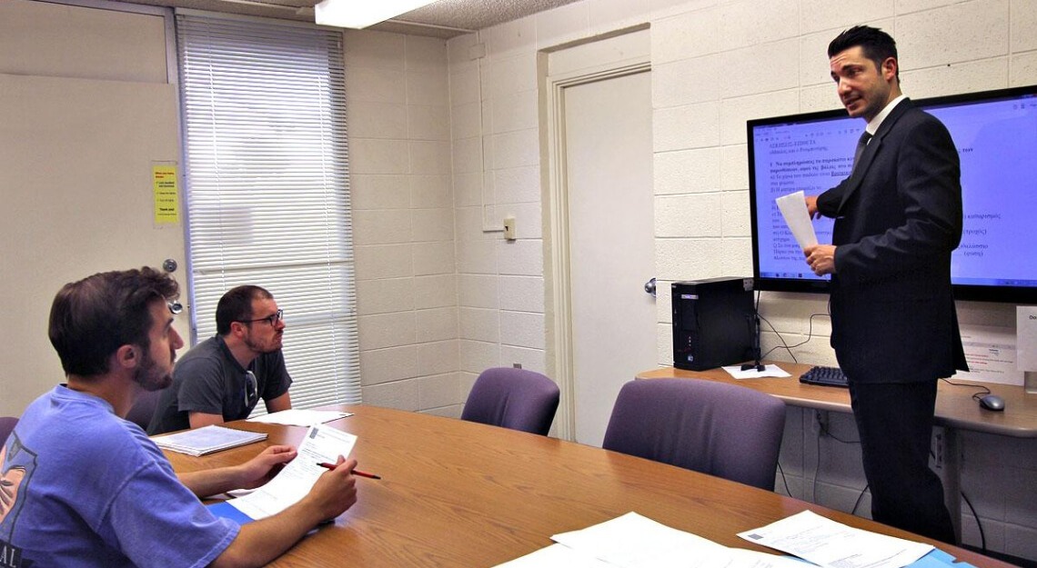 Professor teaching Greek to a small group of students.